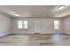 Open living room with modern flooring, neutral walls, and natural light from two windows at 109 Stone Ridge Dr, Smithfield, NC 27577