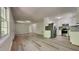 Open living space with modern floors and open access to a kitchen with stainless steel appliances at 109 Stone Ridge Dr, Smithfield, NC 27577