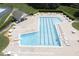 High angle view of a community pool with lounge chairs and tables on an expansive sun deck at 110 Chapelwood Way, Cary, NC 27518