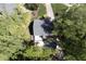 Aerial view of gray home featuring an in-ground pool, outdoor kitchen, and lush yard at 110 Chapelwood Way, Cary, NC 27518