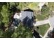 Aerial view of gray home featuring an in-ground pool, outdoor kitchen, and landscaped yard at 110 Chapelwood Way, Cary, NC 27518