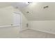 Attic space with neutral walls, carpeted flooring, and door to storage at 110 Chapelwood Way, Cary, NC 27518