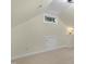 Attic space with neutral walls, a low window, a small door, and carpeted flooring at 110 Chapelwood Way, Cary, NC 27518