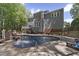 Amazing backyard featuring a pool with a waterfall slide and lush, green surroundings at 110 Chapelwood Way, Cary, NC 27518