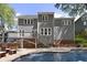 Beautiful backyard showcasing a pool with a stone bar and outdoor entertaining space at 110 Chapelwood Way, Cary, NC 27518