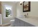 Bathroom vanity with marble countertop, chrome faucet and framed mirror with window view at 110 Chapelwood Way, Cary, NC 27518