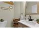 Charming bathroom with natural wood vanity, ample storage, and decor at 110 Chapelwood Way, Cary, NC 27518