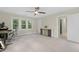 Spacious bedroom with desk, gaming computer, entertainment center, ceiling fan and large windows at 110 Chapelwood Way, Cary, NC 27518
