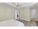 Spacious bedroom featuring a neutral color palette, hardwood floors, and abundant natural light at 110 Chapelwood Way, Cary, NC 27518