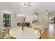 Open dining area with natural light, light fixtures, wood floors, and an easy transition to other rooms at 110 Chapelwood Way, Cary, NC 27518