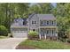 Charming two-story home featuring a well-manicured lawn, inviting front porch and a two-car garage at 110 Chapelwood Way, Cary, NC 27518