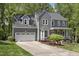 Charming two-story home featuring a well-manicured lawn, inviting front porch and a two-car garage at 110 Chapelwood Way, Cary, NC 27518