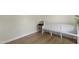 Bright hallway showcasing a white bench, a vintage record player, and sleek, light-toned hardwood flooring at 110 Chapelwood Way, Cary, NC 27518