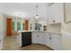 Bright kitchen features white cabinets, stainless steel appliances, quartz counters, and eat-in dining area at 110 Chapelwood Way, Cary, NC 27518