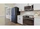 Modern kitchen showcasing stainless steel appliances, quartz countertops and white cabinets, with open layout at 110 Chapelwood Way, Cary, NC 27518