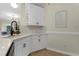 Bright kitchen features white cabinets, marble countertops, neutral backsplash, and modern black faucet at 110 Chapelwood Way, Cary, NC 27518