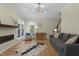 Inviting living room features a cozy couch, modern fireplace, and large windows offering natural light at 110 Chapelwood Way, Cary, NC 27518