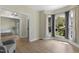 Inviting living room featuring hardwood floors, large windows, and neutral wall color, with modern light fixture at 110 Chapelwood Way, Cary, NC 27518