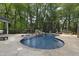 Stunning backyard oasis with a pool, slide, waterfall feature, and stone outdoor bar at 110 Chapelwood Way, Cary, NC 27518