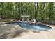 Large backyard pool featuring a slide, waterfall, lounge area, and outdoor fireplace at 110 Chapelwood Way, Cary, NC 27518