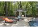 Inviting pool area with lounge chairs, pergola, and fireplace, perfect for relaxation at 110 Chapelwood Way, Cary, NC 27518