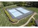 Aerial view of two community tennis courts surrounded by lush green grass and trimmed hedges at 110 Chapelwood Way, Cary, NC 27518