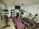 Home gym in basement features exercise equipment, concrete floors, and a television for entertainment at 1102 Poplar Ave, Garner, NC 27529