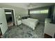 Bright bedroom with large windows, ceiling fan, and stylish rug at 1102 Poplar Ave, Garner, NC 27529