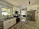 Modern kitchen features stainless steel appliances, granite countertops, white cabinets, and a subway tile backsplash at 1102 Poplar Ave, Garner, NC 27529