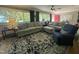 Bright living room featuring hardwood floors, neutral paint, and a large window showcasing the well-landscaped yard at 1102 Poplar Ave, Garner, NC 27529