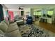 Open living space flows into the kitchen, featuring large windows and comfortable seating at 1102 Poplar Ave, Garner, NC 27529