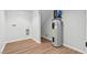Spacious unfinished basement featuring an utility sink, hot water heater, and washer/dryer hookups at 1124 Hardimont Rd, Raleigh, NC 27609