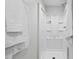 Bathroom featuring a modern white shower with built-in shelves and fresh, white towels at 1124 Hardimont Rd, Raleigh, NC 27609