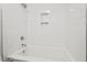 Modern bathroom with a clean, white tiled shower and bathtub, offering a serene and spa-like experience at 1124 Hardimont Rd, Raleigh, NC 27609