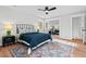Comfortable bedroom with a ceiling fan, large rug, and mirrored closet doors at 1124 Hardimont Rd, Raleigh, NC 27609