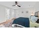 Cozy bedroom with neutral walls, a ceiling fan, and unique wall decor at 1124 Hardimont Rd, Raleigh, NC 27609