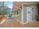 View of the home's light gray siding and wooden deck with table and chairs, creating an inviting outdoor space at 1124 Hardimont Rd, Raleigh, NC 27609