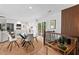 Bright dining area featuring a modern table, light wood floors, and sliding glass doors to a deck at 1124 Hardimont Rd, Raleigh, NC 27609