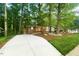 Charming single story brick home surrounded by mature trees and well-maintained landscaping at 1124 Hardimont Rd, Raleigh, NC 27609