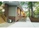 The brick exterior of a charming home showcases a well-manicured lawn and easy access to the stairs at 1124 Hardimont Rd, Raleigh, NC 27609