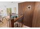 Elegant hallway featuring a stylish bar cart, wood paneling, designer lighting, and hardwood floors, creating a sophisticated ambiance at 1124 Hardimont Rd, Raleigh, NC 27609