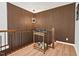Elegant hallway featuring a stylish bar cart, wood paneling, designer lighting, and hardwood floors, creating a sophisticated ambiance at 1124 Hardimont Rd, Raleigh, NC 27609