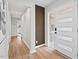Bright hallway featuring a modern front door and stylish wood-paneled accent wall at 1124 Hardimont Rd, Raleigh, NC 27609