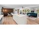 Bright living room boasts a large island, light hardwood floors, and lots of natural light at 1124 Hardimont Rd, Raleigh, NC 27609