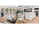 Open-concept living space featuring hardwood floors, modern kitchen with quartz island, and ample natural light at 1124 Hardimont Rd, Raleigh, NC 27609