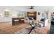 Bright open concept living space with modern furnishings, hardwood floors, and combined kitchen and dining area at 1124 Hardimont Rd, Raleigh, NC 27609