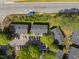 Aerial view of townhomes, parking lot, and a nearby highway with some greenery at 115 Coleridge Ct, Carrboro, NC 27510