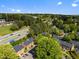 Scenic aerial view of townhome community near major thoroughfare and wooded areas at 115 Coleridge Ct, Carrboro, NC 27510