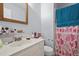 Bathroom featuring a clean white vanity, toilet, and shower with heart-themed curtain at 115 Coleridge Ct, Carrboro, NC 27510