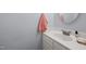Clean bathroom featuring a white vanity, round mirror, and towel at 115 Coleridge Ct, Carrboro, NC 27510